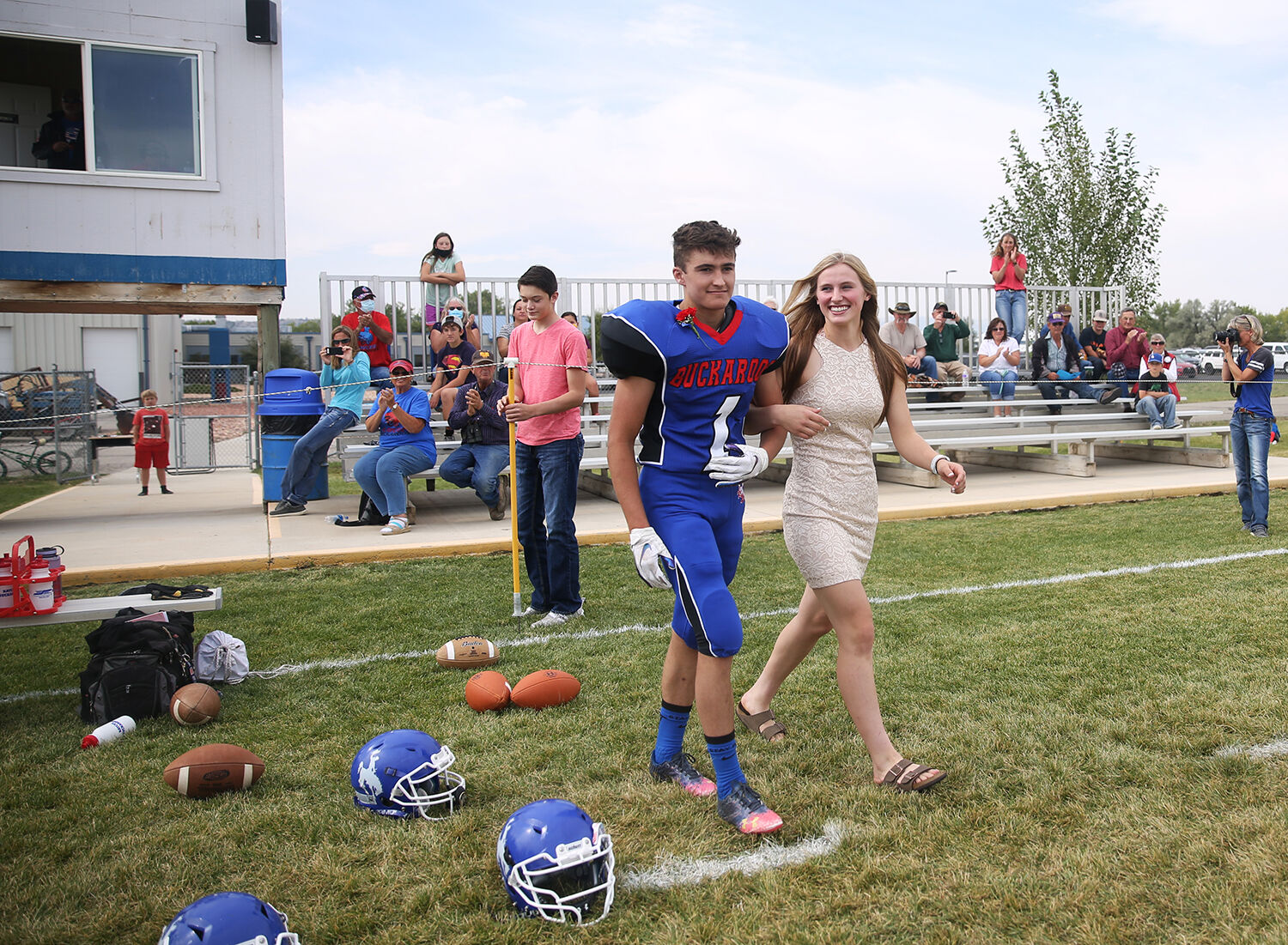 Dylan Fauber and Tinley Pierson walk onto the field